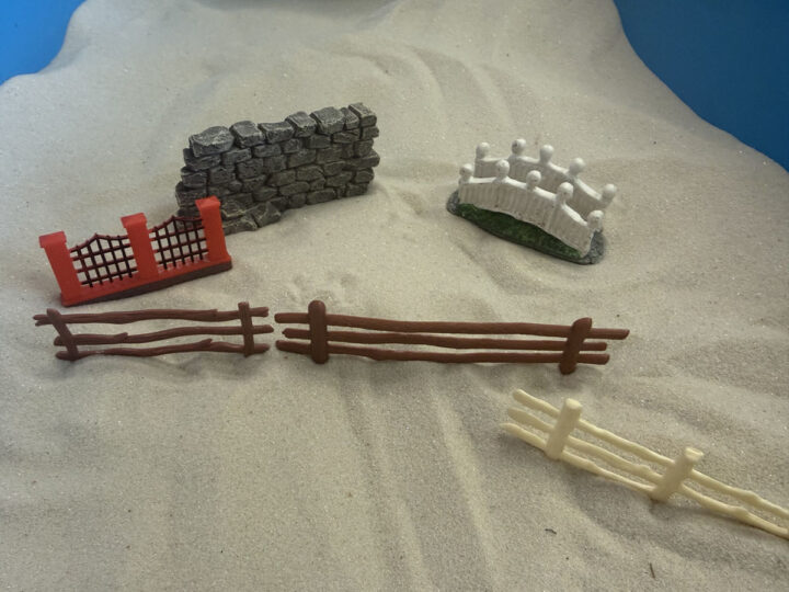 multiple small fence toys used in sandtray therapy in Ivy's office at Treehouse Counseling in Beaverton, OR
