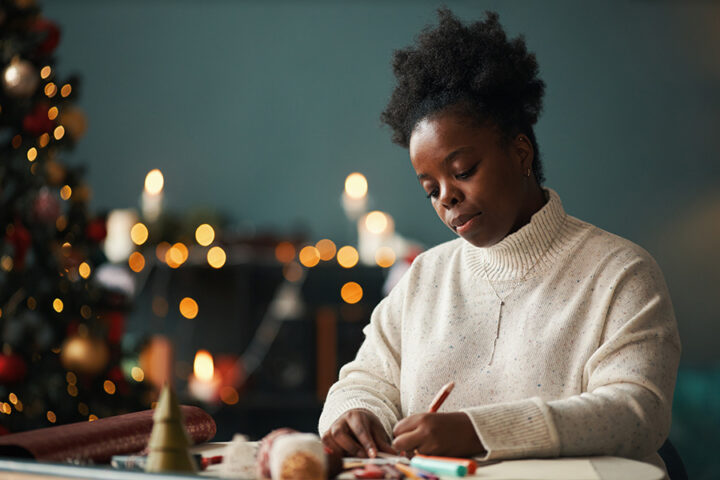 Black woman writes pages for alternatives to new years resolutions in 2026