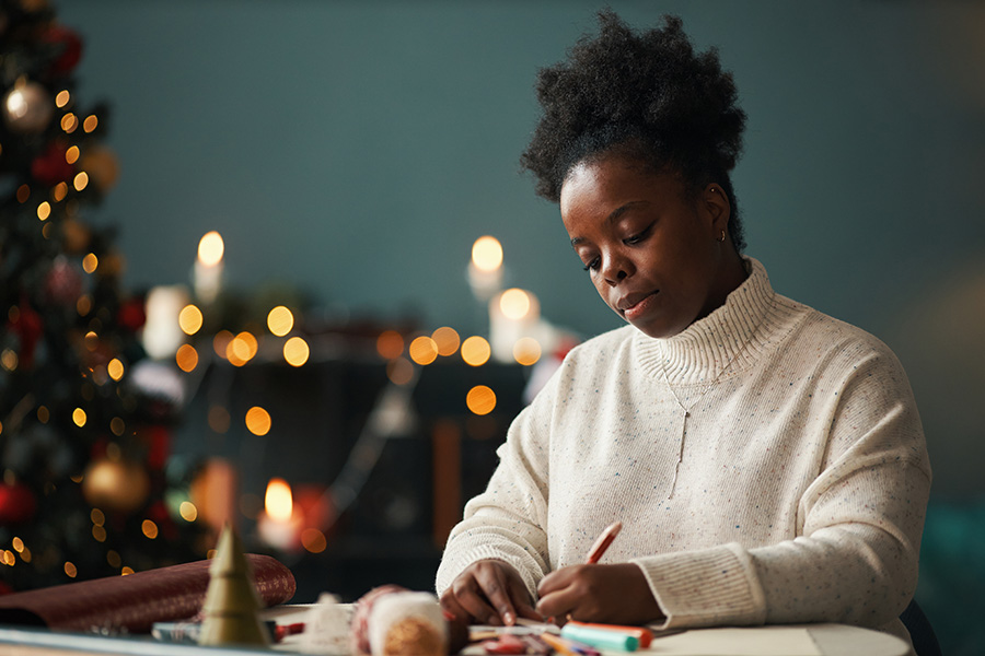 Black woman writes pages for alternatives to new years resolutions in 2026